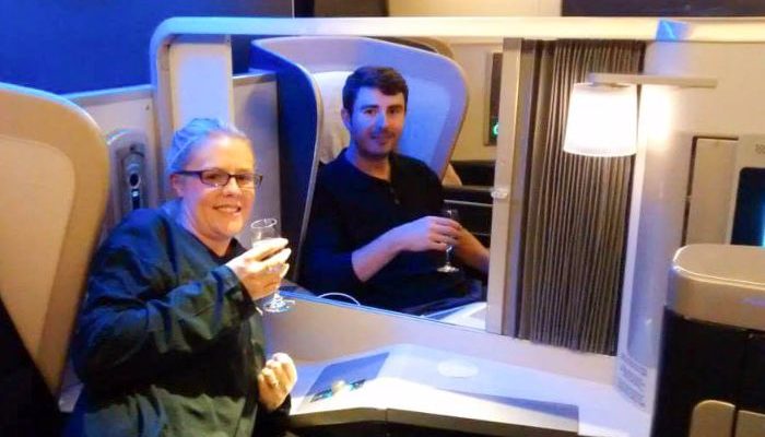 Enjoying champagne in First class
