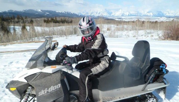 me on a snowmobile in Grant Teton National Park