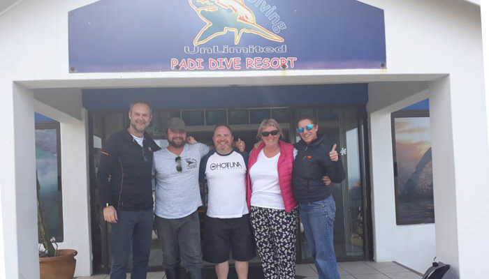 group of people in front of dive shop