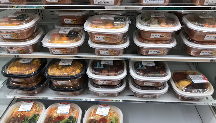 a shelf with food in plastic containers