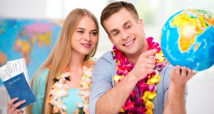 a man and woman wearing leis and smiling
