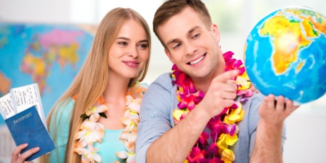 a man and woman wearing leis and smiling