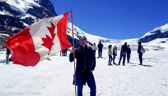 Jason on the Athabasca Glacier with the Canadian flag