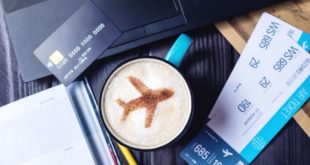 Credit card and plane on a coffee with flight tickets