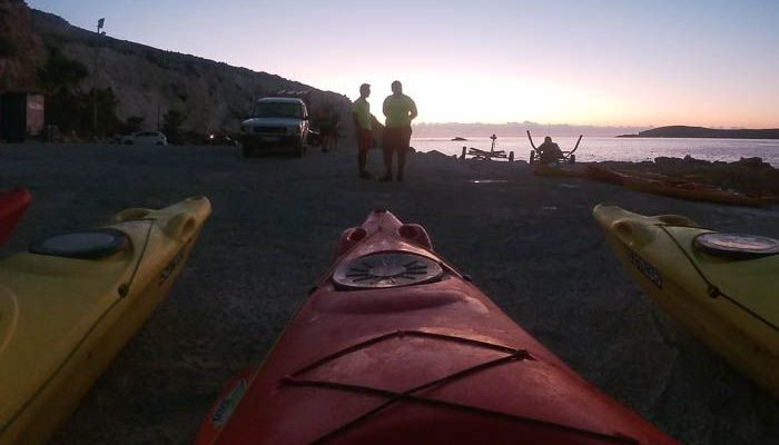 Kayaks on a beach at sunrise