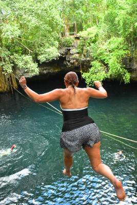 Jumping from the cliff into the cenote