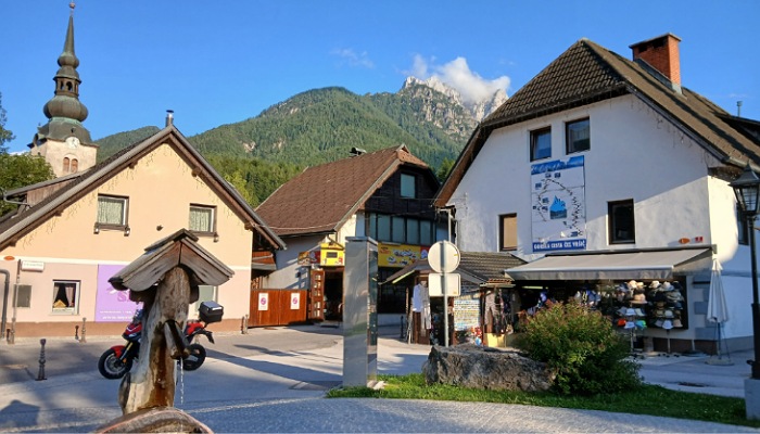a group of buildings with mountains in the background