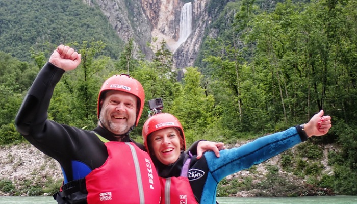 a man and woman in water rafting