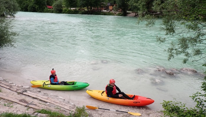 two people in kayaks on a river