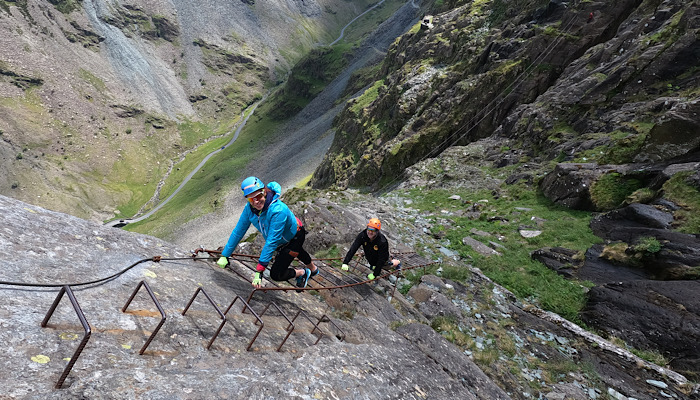 a group of people climbing a metal ladder