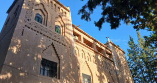 a building with a tree in the background