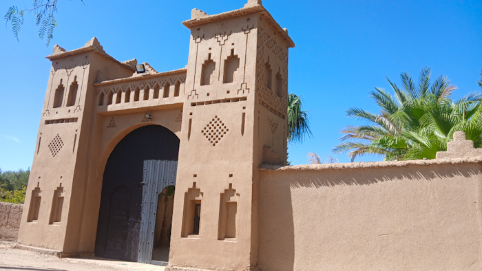 a building with a door and a wall