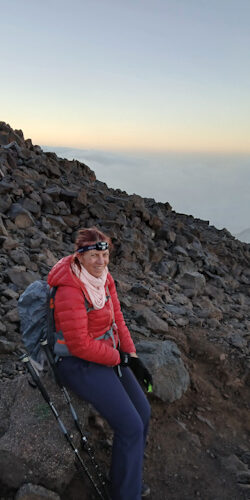 a woman sitting on a rock