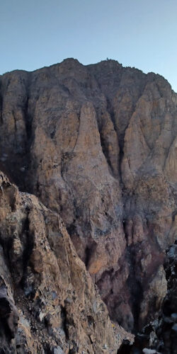 a rocky mountain with blue sky