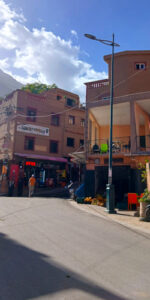 a street with buildings and a scooter